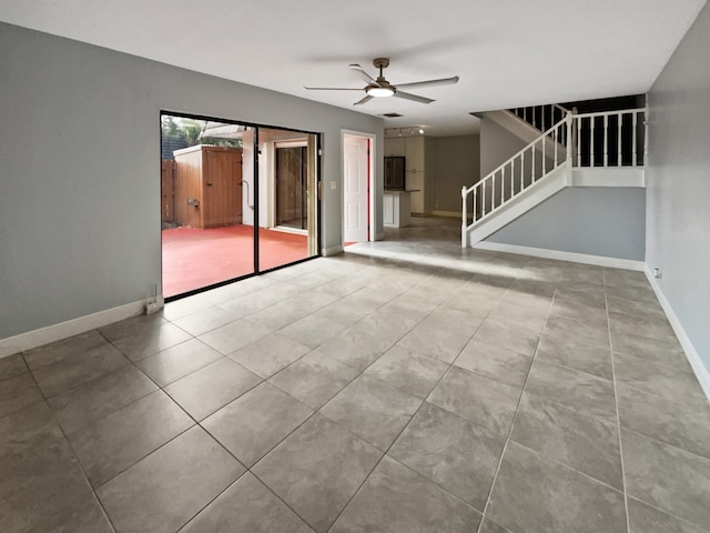 spare room featuring tile floors and ceiling fan