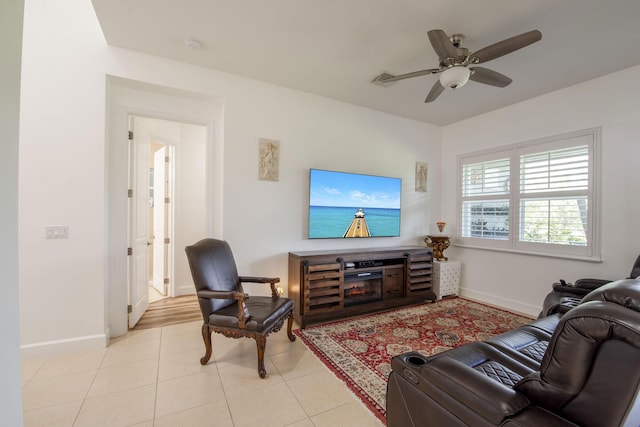 living room with ceiling fan and light tile patterned floors