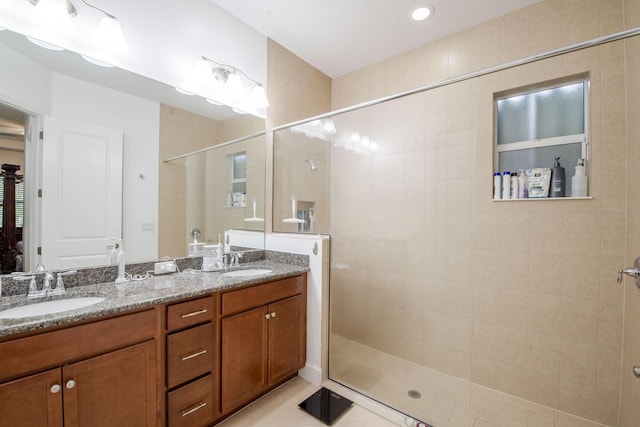 bathroom featuring tile patterned floors, vanity, and an enclosed shower