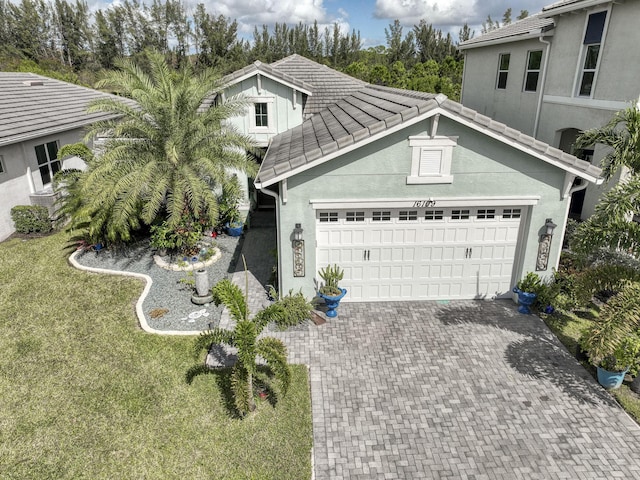 view of front of home with a front yard and a garage