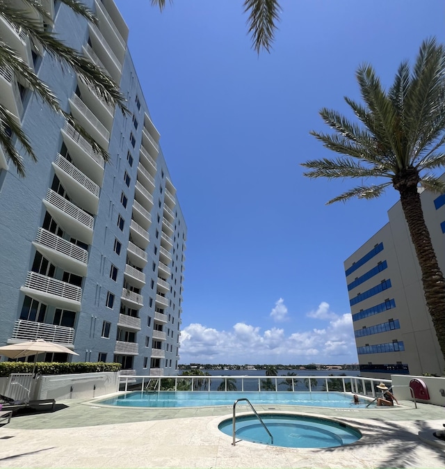 view of swimming pool featuring a hot tub