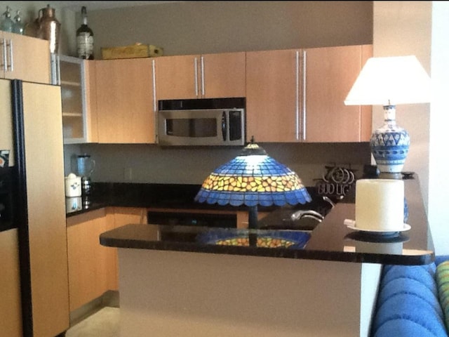 kitchen featuring appliances with stainless steel finishes and light brown cabinets