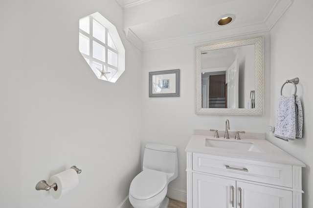 bathroom with crown molding, vanity, and toilet