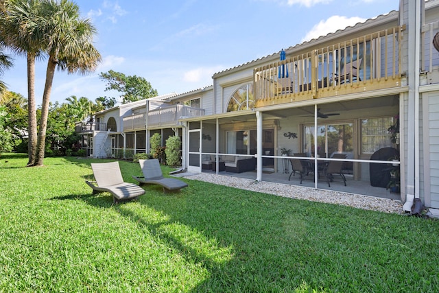 back of house featuring a yard, a patio area, and a balcony