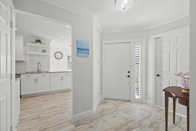 tiled entryway featuring sink and ornamental molding