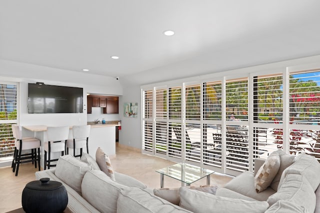 living room with light tile patterned floors and a healthy amount of sunlight