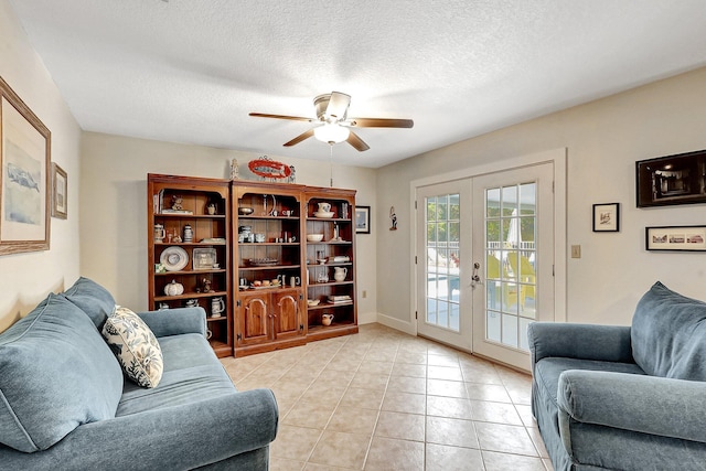 tiled living room with french doors, a textured ceiling, and ceiling fan