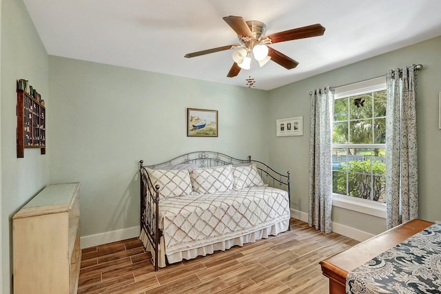 bedroom featuring ceiling fan and multiple windows