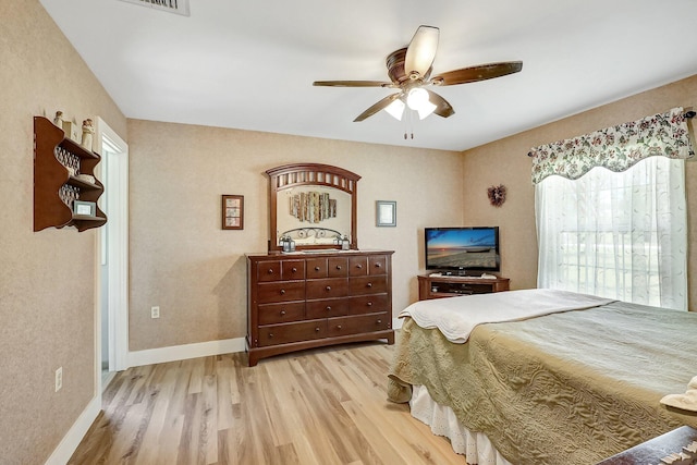 bedroom with light hardwood / wood-style floors and ceiling fan