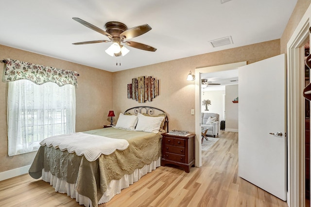 bedroom with ceiling fan and light hardwood / wood-style floors