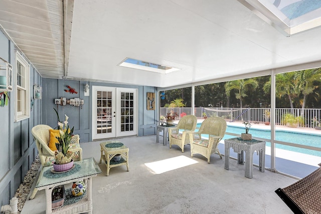 sunroom / solarium featuring a skylight and french doors