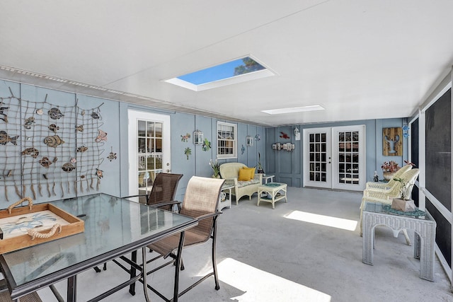 office area with french doors, concrete floors, and a skylight