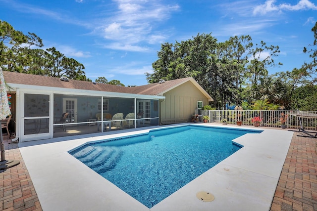 view of swimming pool with a patio area and a sunroom