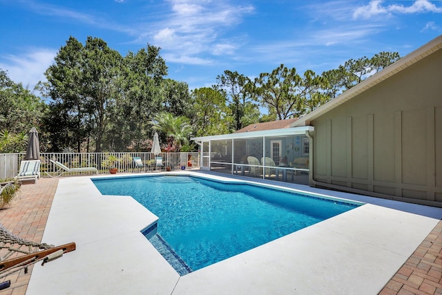 view of pool with a sunroom and a patio area