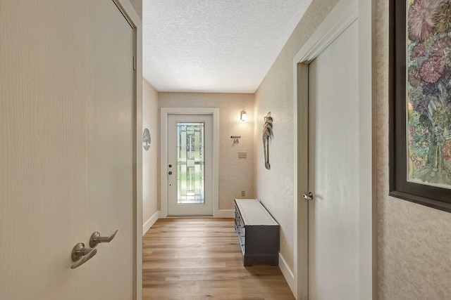 entryway featuring light hardwood / wood-style floors and a textured ceiling