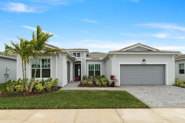 view of front of home featuring a garage and a front lawn