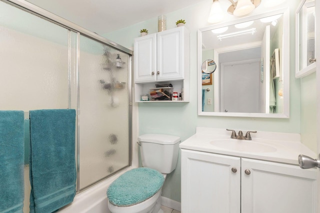 full bathroom featuring shower / bath combination with glass door, toilet, and vanity with extensive cabinet space