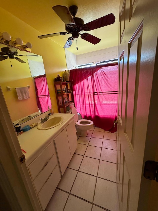 bathroom with ceiling fan, vanity, toilet, and tile floors