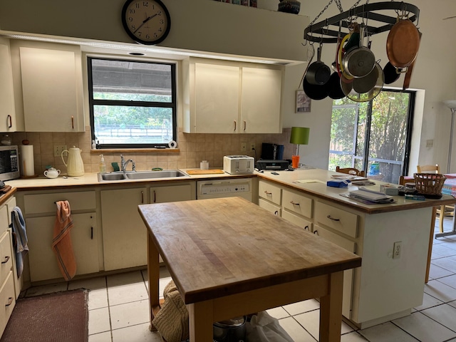 kitchen with sink, backsplash, and plenty of natural light