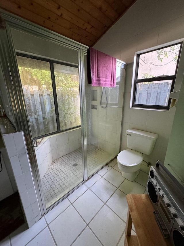 bathroom featuring toilet, tile flooring, an enclosed shower, wood ceiling, and lofted ceiling