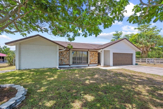 ranch-style home featuring a garage and a front yard