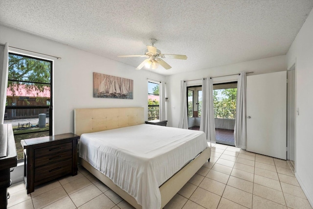 tiled bedroom featuring ceiling fan, access to exterior, and a textured ceiling