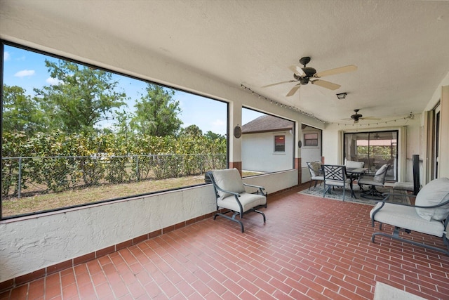 sunroom / solarium featuring ceiling fan