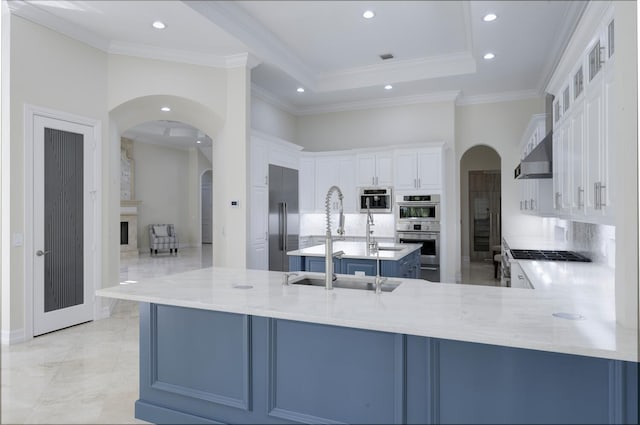 kitchen featuring white cabinetry, sink, stainless steel appliances, backsplash, and kitchen peninsula