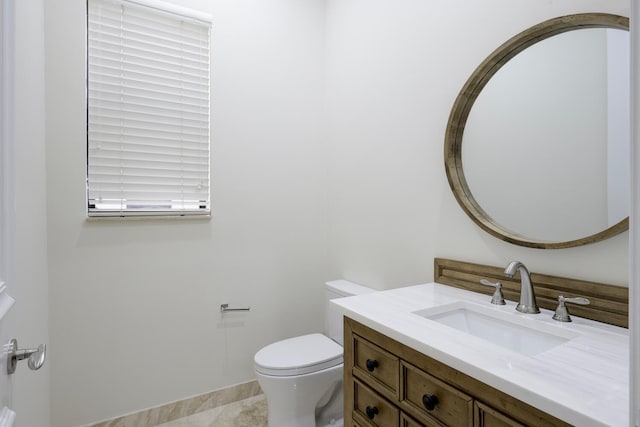 bathroom featuring tile patterned flooring, vanity, and toilet