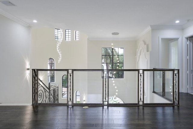 interior space with dark hardwood / wood-style flooring and ornamental molding