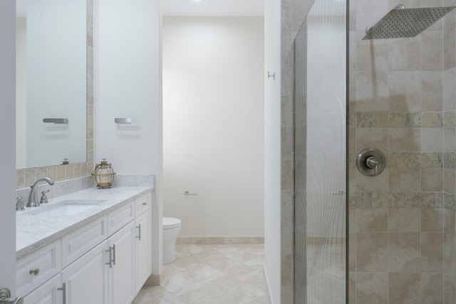 bathroom featuring tile patterned floors, vanity, toilet, and tiled shower