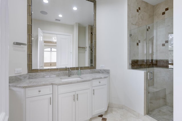 bathroom with tile patterned floors, vanity, and walk in shower