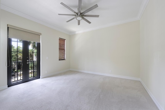 spare room with light carpet, french doors, ceiling fan, and ornamental molding