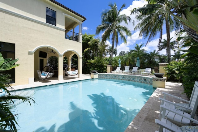 view of swimming pool featuring a patio and ceiling fan