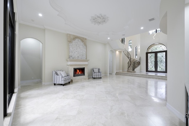 sitting room featuring french doors and crown molding