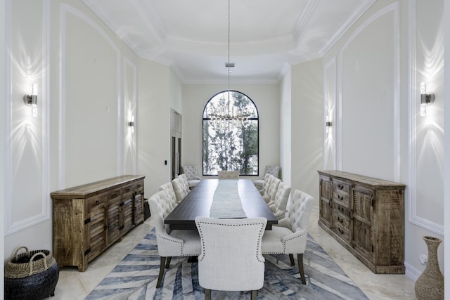 dining area with a chandelier, a tray ceiling, and crown molding