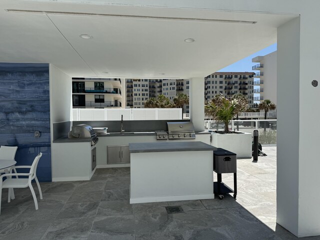 view of patio / terrace with a sink, a grill, a city view, and area for grilling