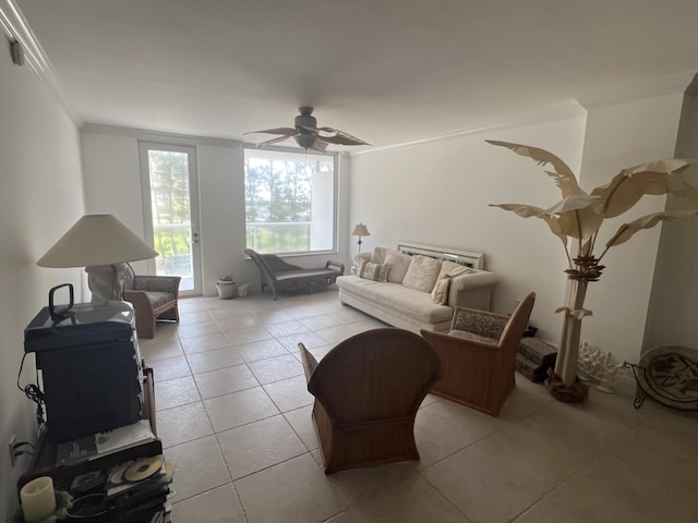 living room with light tile patterned floors, a ceiling fan, and crown molding