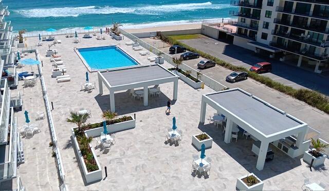 birds eye view of property with a beach view and a water view