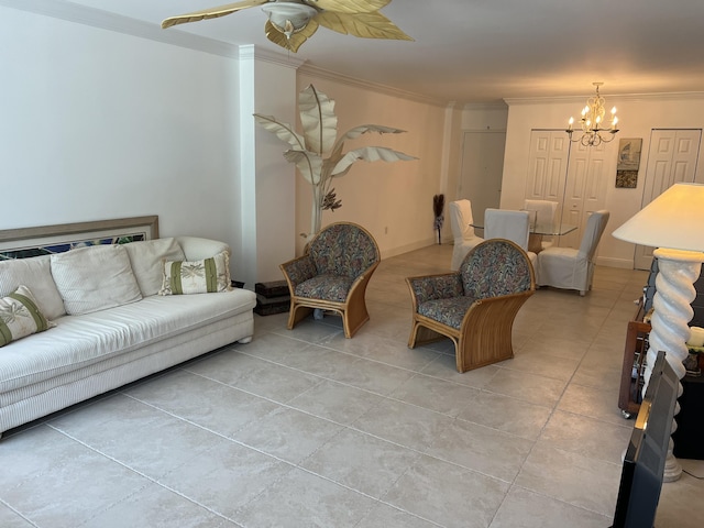 living area featuring ornamental molding, ceiling fan with notable chandelier, baseboards, and light tile patterned floors