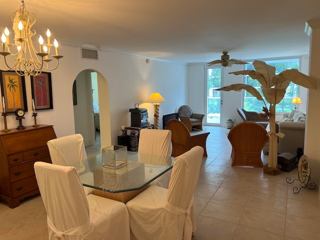 tiled dining space featuring crown molding and ceiling fan with notable chandelier