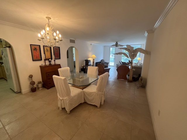 dining space featuring arched walkways, crown molding, baseboards, and ceiling fan with notable chandelier