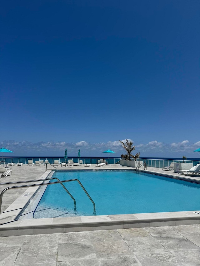 view of pool with a water view