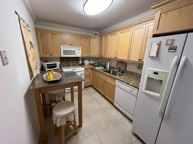 kitchen featuring white appliances, crown molding, sink, dark stone countertops, and light tile patterned flooring