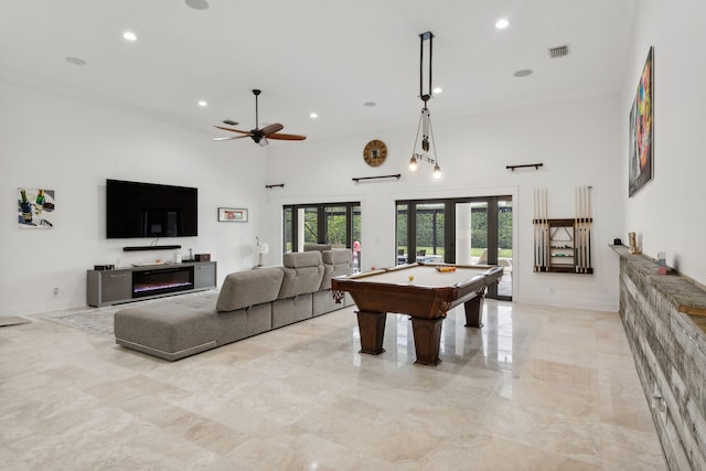 playroom featuring a towering ceiling, pool table, ceiling fan, and french doors