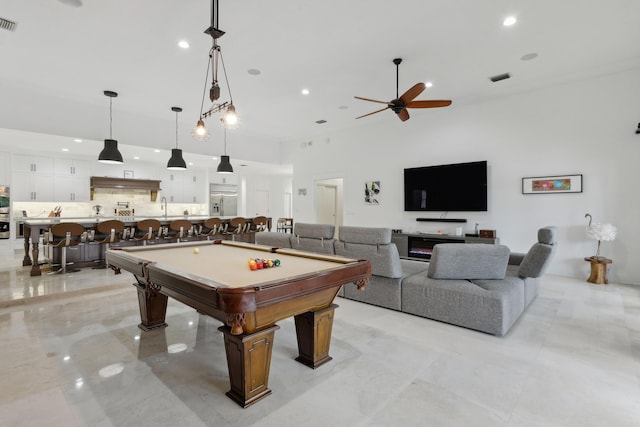 game room with a high ceiling, sink, ceiling fan, and billiards