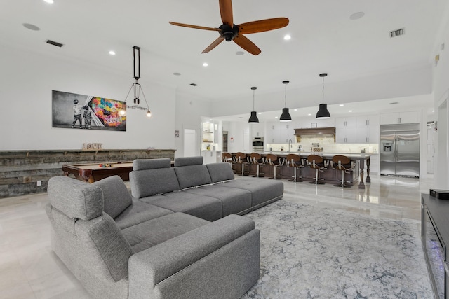 living room with sink and ceiling fan