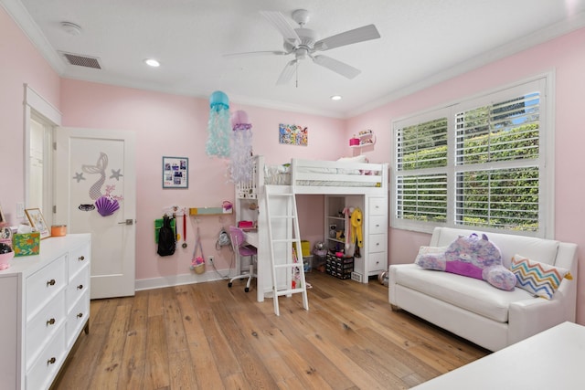 bedroom featuring ornamental molding, ceiling fan, and light wood-type flooring