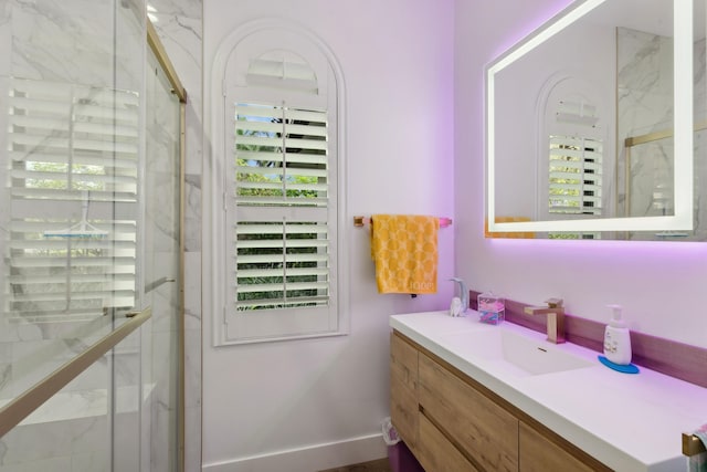 bathroom with vanity and a shower with shower door