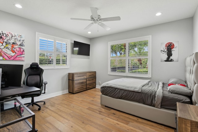 bedroom with ceiling fan and light wood-type flooring